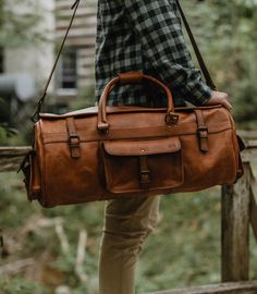 Leather Duffle Bag | Roosevelt Collection | Buffalo Jackson | Brown Leather Duffel Brown Shoulder Bag For Outdoor Activities, Brown Leather Duffle Bag For Outdoor Activities, Leather Duffle Bag With Large Capacity For Outdoor, Travel Satchel Bag For Outdoor Activities, Brown Large Capacity Travel Bag For Outdoor Activities, Large Capacity Brown Travel Bag For Outdoor Activities, Rugged Leather Bags For Outdoor, Brown Waxed Finish Shoulder Bag For Weekend Trips, Rugged Outdoor Bags With Large Capacity