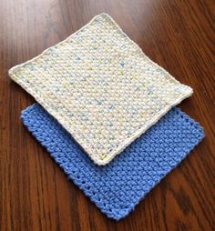 three crocheted cloths sitting on top of a wooden table