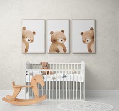 a baby's room with two pictures on the wall and a rocking horse next to it