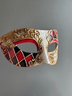 This Venetian style mask in red, black, and gold is perfect for any formal occasion or masquerade event! Thank you for supporting small businesses and hope our products bring you and loved ones some joy and humor in these trying times.    I N C L U D E D Masks come with matching double sided satin ribbons attached. S I Z E  Adult size. Detailed dimensions available upon request. C U S T O M I Z A T I O N If you would like to color & embellish the mask to match your costume/dress, choose custom color and get in touch, we love to work on custom orders!  C O N T A C T  Please contact us via ETSY messages. P H O T O  Images displayed on this listing are property of www.higginscreek.com A B O U T HigginsCreek makes elegant face Masks for masquerade balls, Prom Dances, Bachelorette parties, Grad Masquerade Mask Venetian, Masquerade Mask Vintage, Masculine Masquerade Mask, Mascarade Mask Drawing, Jester Masquerade Mask, Victorian Masked Ball, Fancy Masquerade Mask, Red And Gold Masquerade Party, Men Masquerade Mask