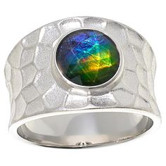 Canadian Ammolite Gems Sterling Silver Round Ammolite Hammered Ring This bold sterling silver ring features a round, multicolored ammolite triplet and handsome, hammered texture. Fossilized ammolite, a rare gem from Alberta, Canada, is known for its mesmerizing kaleidoscope of natural colors. By Kenneth Bradley.       Approx. 15/16"L x 3/4"W x 15/16"H; shank 1/8"W     Stamped .925; rhodium plating     Sterling silver, wide-band ring has round ammolinte/quartz triplet bezel-set in center     Slig Modern Sterling Silver Oval Cabochon Ring, Oval Cabochon Sterling Silver Gemstones, Sterling Silver Oval Opal Cabochon Ring, Artisan Silver Opal Cabochon Ring, Ammolite Ring, Hammered Silver Ring, Hammered Rings, Hammered Sterling Silver, Rare Gems