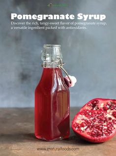 pomegranate syrup in a glass bottle next to a whole pomegranate