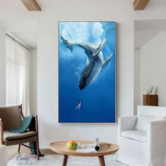 a living room filled with furniture and a painting on the wall above a coffee table