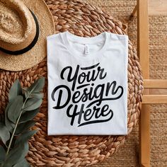 a t - shirt mockup on a wicker basket with a straw hat and leaves