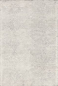 a white rug with squares and lines on it