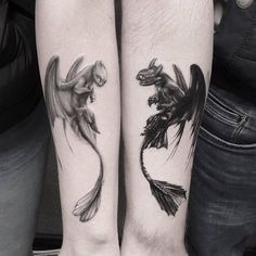 two people with matching tattoos on their legs, one has a dragon and the other has a fish