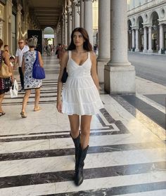 White Dress Black Boots Aesthetic, Dresses With Boots Summer, White Mini Dress And Cowboy Boots, Mini Dress And Cowboy Boots Outfit, White Cowboy Boots Outfit Aesthetic, Girly Cowboy Boots Outfit, Dress With Black Cowgirl Boots, Black Cowboots Outfits, White Mini Dress Black Boots