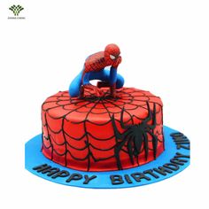 a spiderman birthday cake on a blue plate