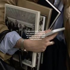 a person holding several books with a quote on it that reads, remember every second you waste doing nothing right now