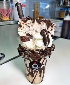 an ice cream sundae with oreo cookies and milkshake on the top