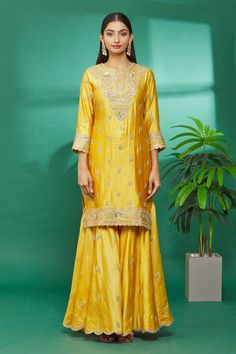 Yellow kurta with floral hand embroidery. Paired with embroidered sharara and organza dupatta.
Component: 3
Pattern: Embroidered
Type Of Work: Floral
Neckline: Round
Sleeve Type: Three Quarter
Fabric: Kurta and Sharara: Pure spun silk, Dupatta: Organza
Color: Yellow
Other Details: 
Floral hand embroidery
Organza dupatta
Occasion: Wedding - Aza Fashions Embroidery Organza, Kurta And Sharara, Embroidered Sharara, Yellow Kurta, Types Of Work, Luxury Sale, Sharara Set, Organza Dupatta, Silk Dupatta