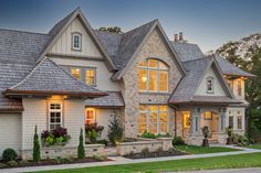 a large house with many windows and landscaping