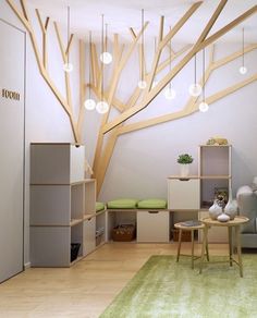 a living room filled with furniture and a tree mural on the wall above it's headboard