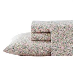 the pink and green floral sheet set is folded on top of each other