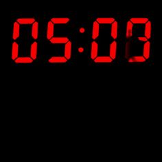 a red digital clock showing the time on black background