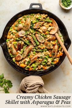 creamy chicken sausage skillet with asparagus and peas in a cast iron skillet