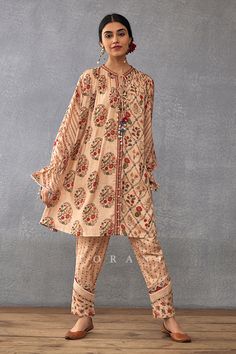 Beige gathered neck kurta with botanic digital and hand block print. Paired with printed pant.
Components: 2
Pattern: Printed
Type Of Work: Digital Print, Hand Block Print
Neckline: Tie-Up
Sleeve Type: Frill
Fabric: Slub Silk, Cotton Silk, Silk Organza
Color: Beige
Other Details: 
Front tie-up
Printed pant
Occasion: Mehendi and Haldi - Aza Fashions Torani Kurta Set, Beige Color Palette, Embroidery Leaf, Kurta Pant Set, Kurta Designs Women, Futuristic Fashion, Kurta With Pants, Fashion App, Silk Organza