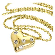 TIFFANY & Co. Etoile 18K Gold 5 Diamond Heart Pendant Necklace Metal: 18K yellow Gold Weight: 9.30 grams Chain: 16" Pendant: 16mm wide Diamond: 5 round brilliant diamonds, carat total weight .15 Hallmark: "©TIFFANY&CO. 750 PT950" on pendant, "TIFFANY&CO. 750" on chain tag Condition: Like new, comes with Tiffany pouch, box and ribbon bow Authenticity Guaranteed Diamond Heart Pendant Necklace, Louis Comfort Tiffany, Heart Pendant Diamond, Tiffany And Co, Metal Necklaces, Diamond Heart, Heart Pendant Necklace, Ribbon Bows, Tiffany & Co.