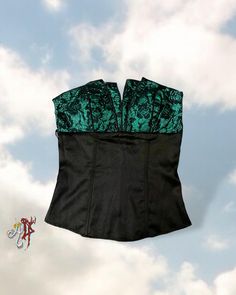 ♻️ Sustainable item *reusing fashion helps protect the Earth ♻️  ➕ Features: ▫️ Vintage Y2k Charlotte Russe ▫️ Deep lush black satin main ▫️ Deep emerald satin/black floral lace bust ▫️ Multi-point small "V" cut upper hem ▫️ Slight shine to the satin areas ▫️ Concealed back zip  ▫️ Built in slight padding ▫️ Strapless ➕ Size: S  ➕Measurements:        Bust: 28-30"       Waist: 26"       Length at front: 17" ➕ Condition: Great condition.  ➕ Tags: Elven, Goth, Victorian, Regal, Fancy, Vampire,  Regency, Whimsigoth, Fairy, Fairycore, Y2K,  ◽️◽️◽️◽️◽️◽️ ☑️ I ship out in 1-2 business days (not including postal delivery time)  ☑️ All photos taken by me and are of actual item #goth #elven #fairycore #whimsigoth #2000s Elven Fairy, Protect The Earth, Goth Victorian, Satin Noir, Strapless Corset, Satin Top, Bustier Top, Green Satin, Bustiers