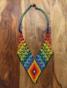 This beautiful beaded necklace is hand-woven by the women of the Embera Chami Indigenous Tribe of Colombia Traditional Handwoven Necklaces For Jewelry Making, Handmade Multicolor Southwestern Beaded Necklaces, Handmade Southwestern Multicolor Beaded Necklaces, Traditional Adjustable Handwoven Necklaces, Traditional Handwoven Adjustable Necklace, Artisan Beaded Adjustable Bib Necklace, Artisan Beaded Bib Necklace With Adjustable Fit, Handmade Artisan Rainbow Necklace, Southwestern Handwoven Beads For Festival