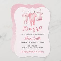 a pink and white baby shower card with clothes hanging on a line, it's a girl