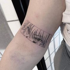 a person with a tattoo on their arm that has an eye in the center and lines across it