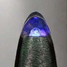 a close up of a vase with a blue light on it's top and bottom