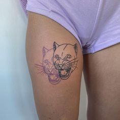 a woman's thigh with a tattoo of a tiger and a cat on it