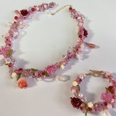 two necklaces with flowers and pearls on them