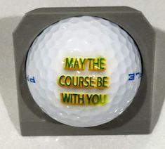 a golf ball with the words maybe course be with you on it