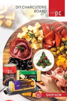 a wooden platter filled with different types of cheeses, meats and vegetables