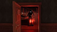 a man riding a bike through a red light filled doorway in a dark room at night