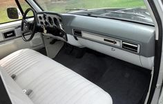 the interior of a car with white leather seats