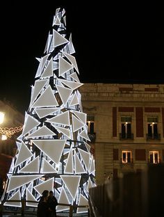 a large white christmas tree lit up at night