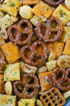 a bowl filled with cheesy crackers and pretzel rings covered in seasoning