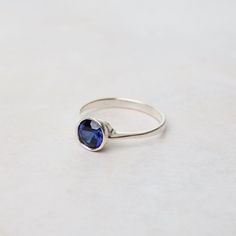 A lovely faceted gemstone ring adds some sparkle & color! Wear alone or stack with others. This synthetic sapphire version is a perfect gift for a September birthstone. Sterling Silver 6mm Round Bezel Set Synthetic Sapphire Adjustable Bezel Set Sapphire Ring Gift, Gift Sapphire Ring With Bezel Setting, Gift Sapphire Ring With Bezel Setting And Round Band, Bezel Set Sapphire Ring Gift, Everyday Crystal Ring With Birthstone, Everyday Sapphire Ring With Bezel Setting, Everyday Sapphire Birthstone Ring With Round Band, Everyday Sapphire Ring Birthstone Round Band, Everyday Round Birthstone Ring