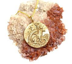 This pendant depicts a flying dragon on one side, and a baby dragon on the reverse. The dragon, a legendary creature symbolizes protection, success, wisdom, loyalty, fearlessness, strength, balance, and immense possibility. Being the master of all four elements of Fire, Water, Earth, and Wind, it also embodies primordial power.This is a large medallion which measures:1 1/8 inch in diameter, made in white bronze, and oxidized for contrast.This item Ships For FREE!!!Please follow us on facebook at Gold Necklace With Dragon Design Collectible, Fantasy Gold Brass Necklaces, Gold Fantasy Brass Necklaces, Gold Brass Fantasy Necklaces, Gold Fantasy Dragon Necklace, Gold Fantasy Necklace With Dragon Design, Fantasy Gold Jewelry With Dragon Design, Gold Fantasy Jewelry With Dragon Design, Dragon Medallion