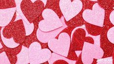 pink and red glitter hearts are arranged in the shape of heart shapes on a wall