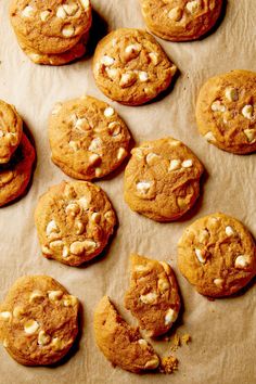 several cookies with white chocolate chips on parchment paper