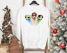 the powerpuff girls hoodie is on display next to a christmas tree