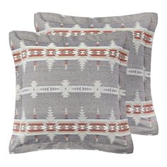 two gray and red pillows sitting next to each other