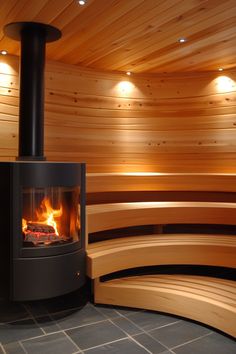 a wood burning stove in a sauna with curved benches and lights on the ceiling