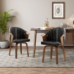 two black leather chairs sitting at a wooden table in front of a potted plant