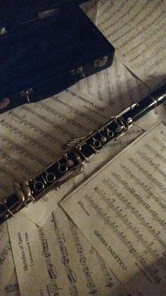 a flute laying on top of sheet music