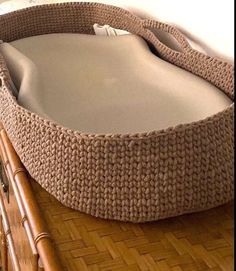 an empty wicker basket sitting on top of a wooden table