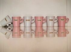 five coffee mugs are lined up in a row