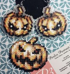 three pieces of bead crafting with pumpkins on them and a price tag