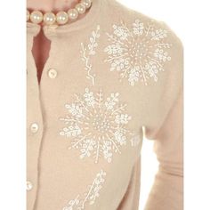 a close up of a person wearing a sweater with snowflakes on it