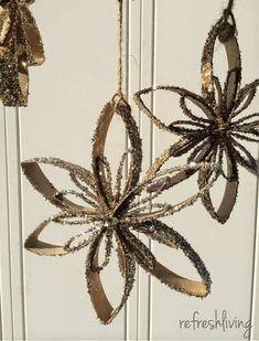 an ornament hanging from the side of a door decorated with ribbons and flowers