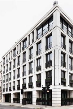 a large white building with balconies on the windows